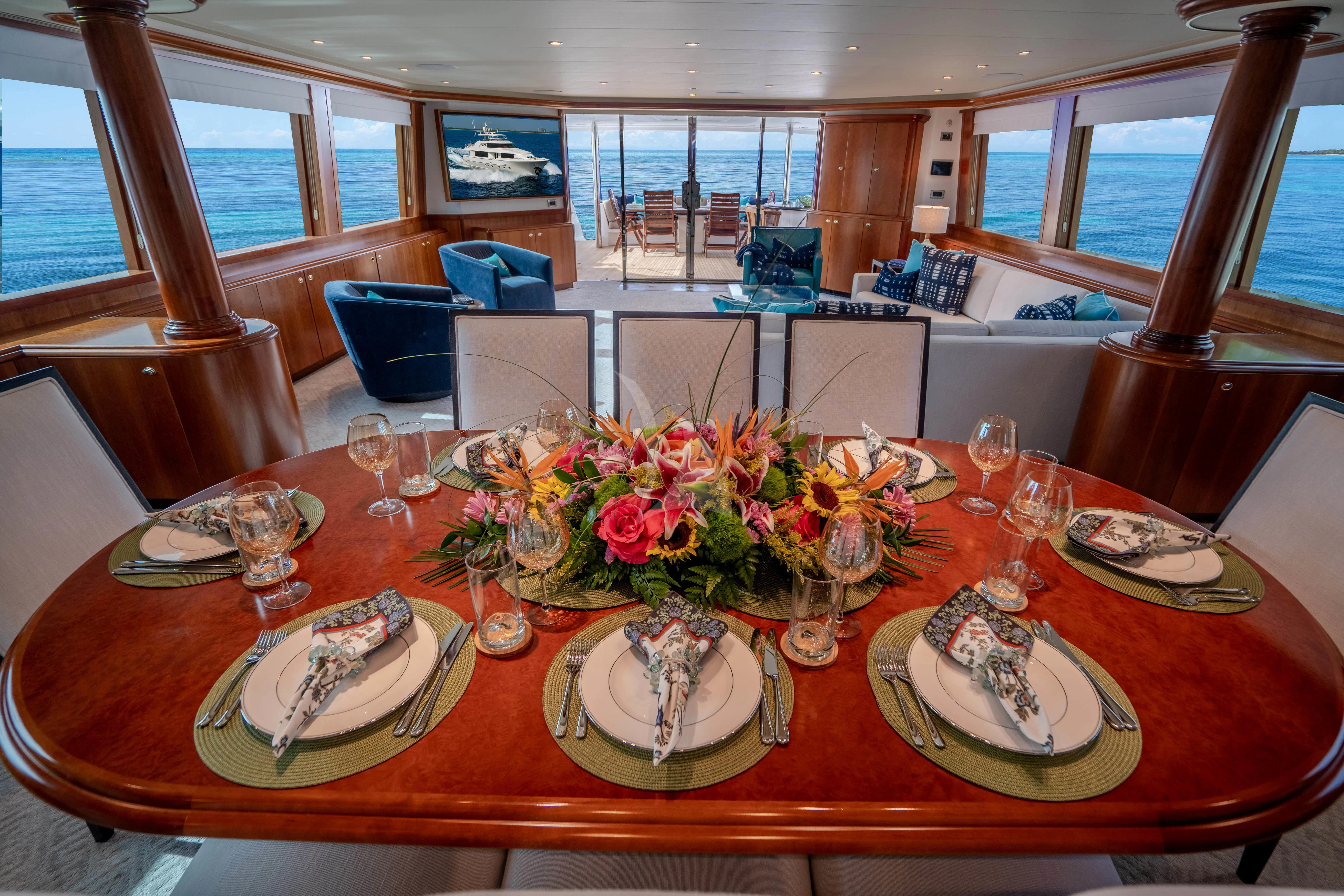 a table with plates and glasses on it aboard INDIGO Yacht for Sale