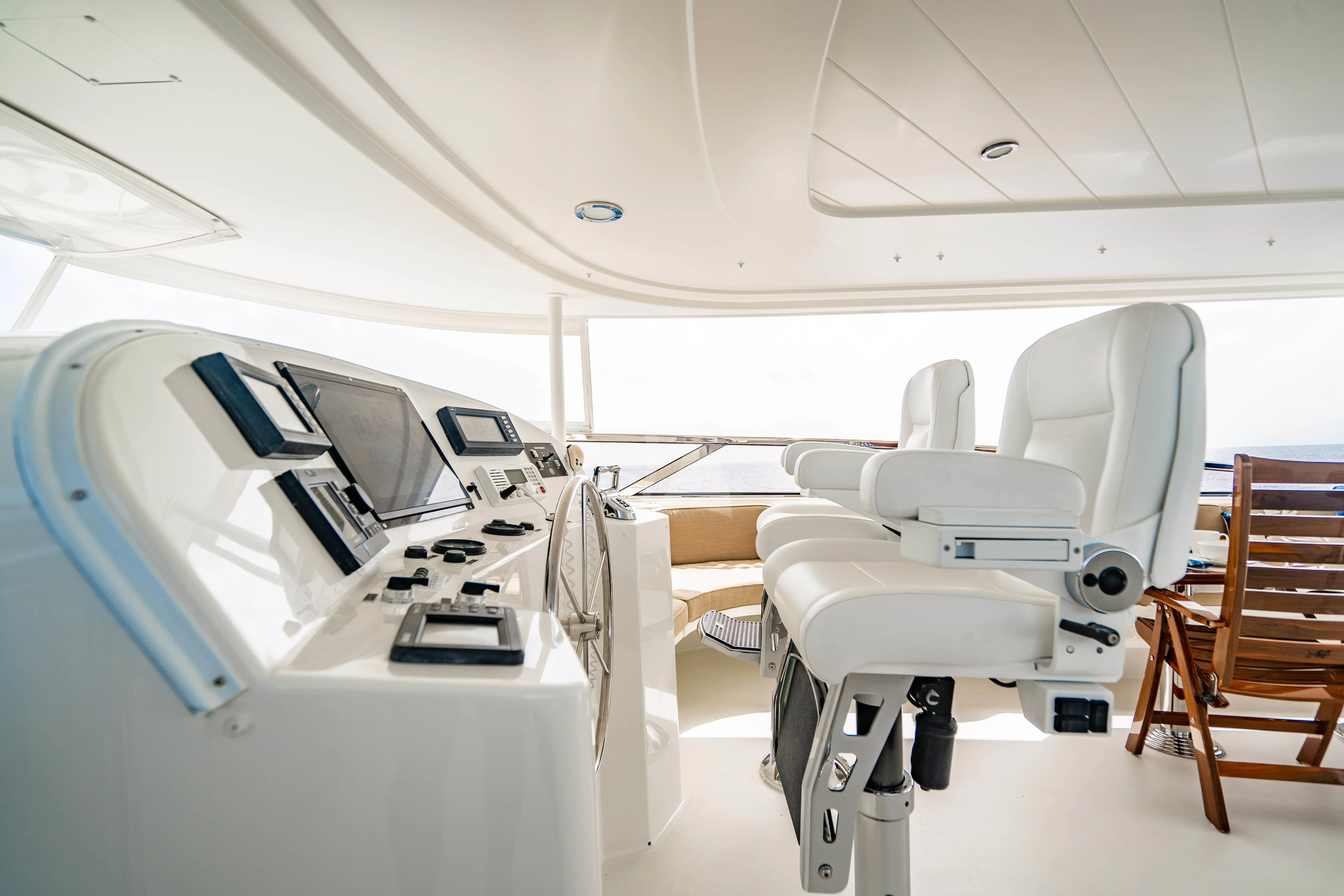 a room with chairs and computers aboard INDIGO Yacht for Sale