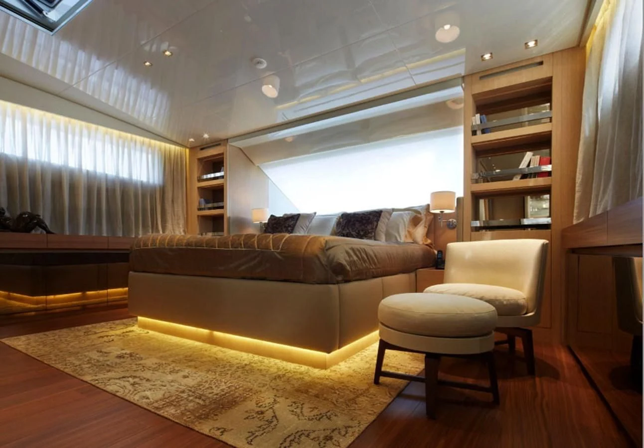 a living room with a couch and a bookcase aboard INDIGO Yacht for Sale