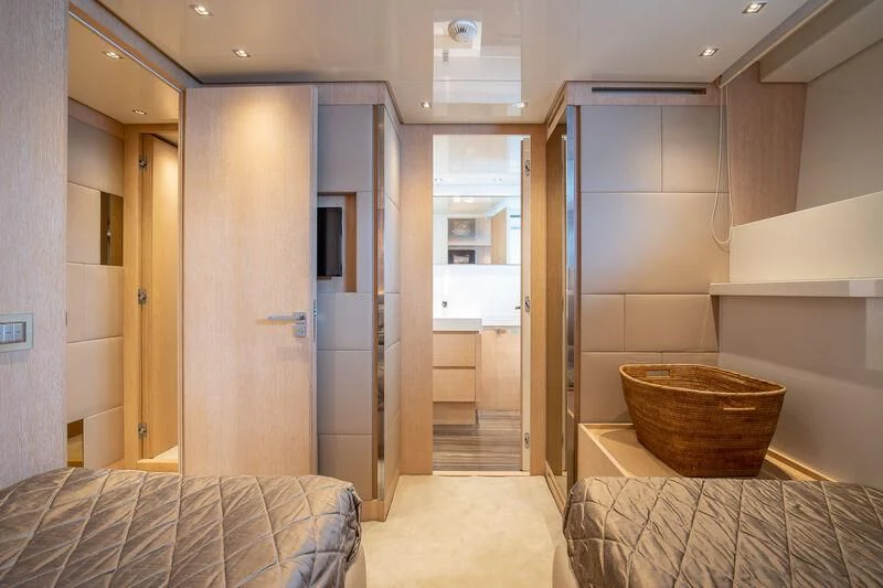 a room with a bed and a couch aboard INDIGO Yacht for Sale