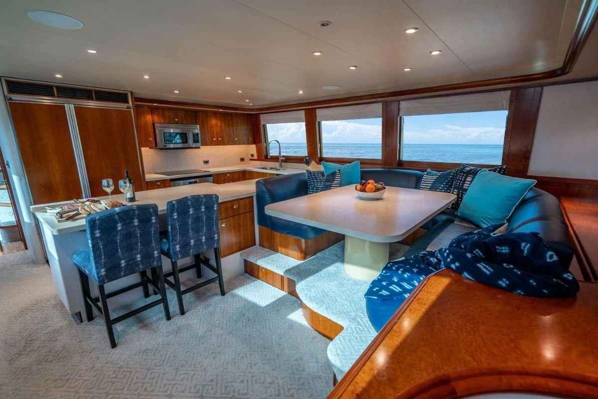 a living room with a kitchen and dining area aboard INDIGO Yacht for Sale