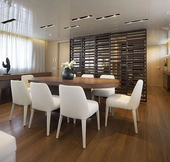 a room with a table and chairs aboard INDIGO Yacht for Sale