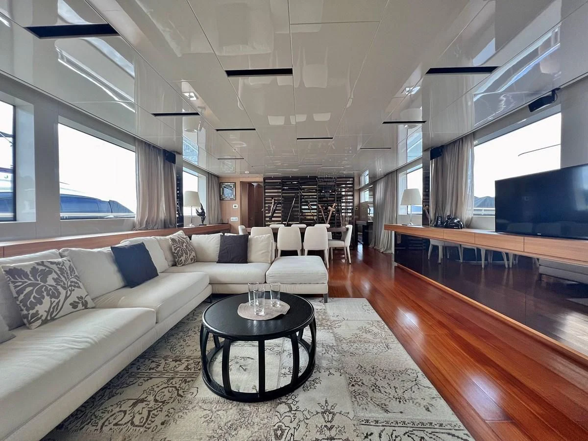 a living room with a wood floor aboard INDIGO Yacht for Sale