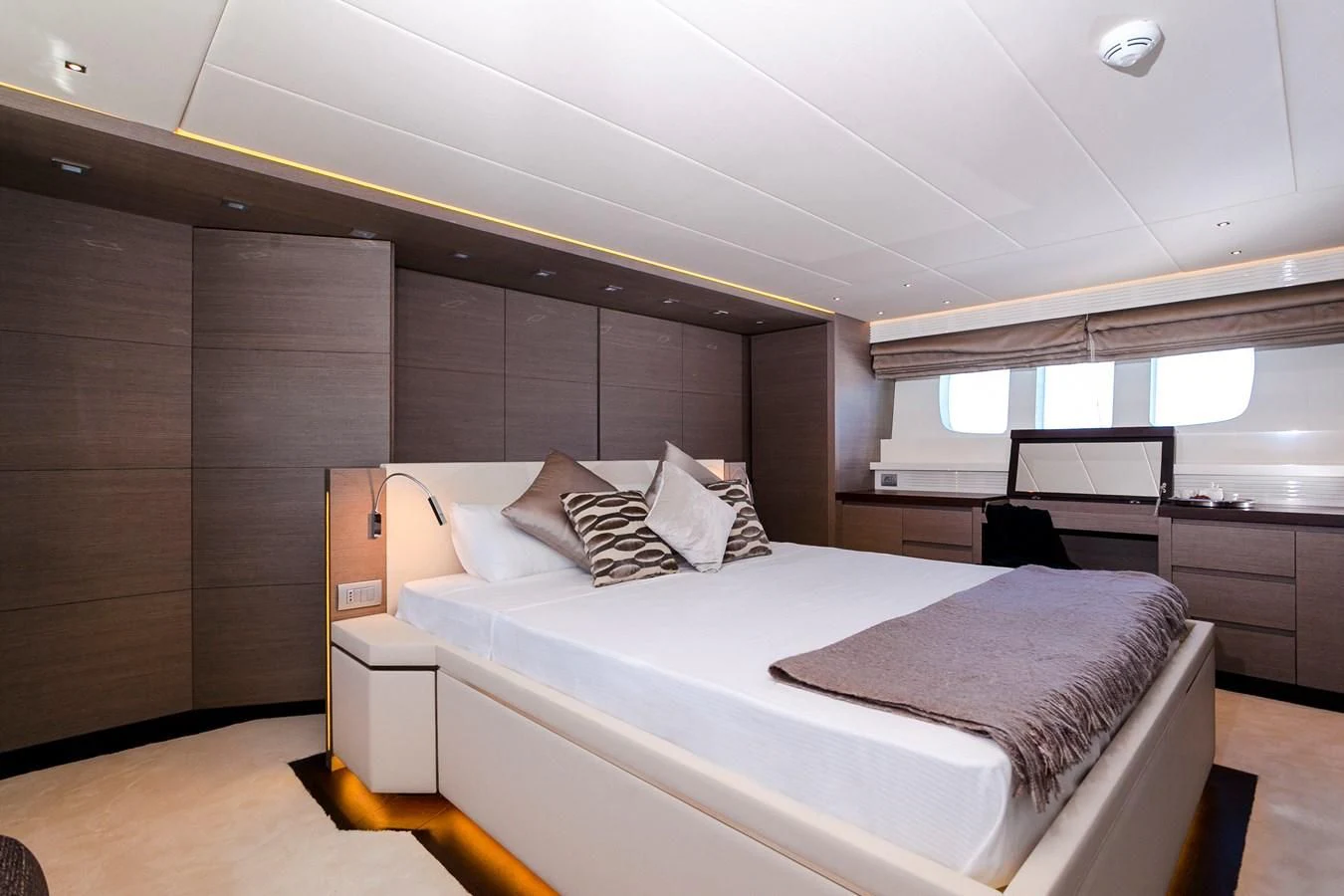 a room with a bed and a desk aboard DADDY'S DREAM 888 Yacht for Charter