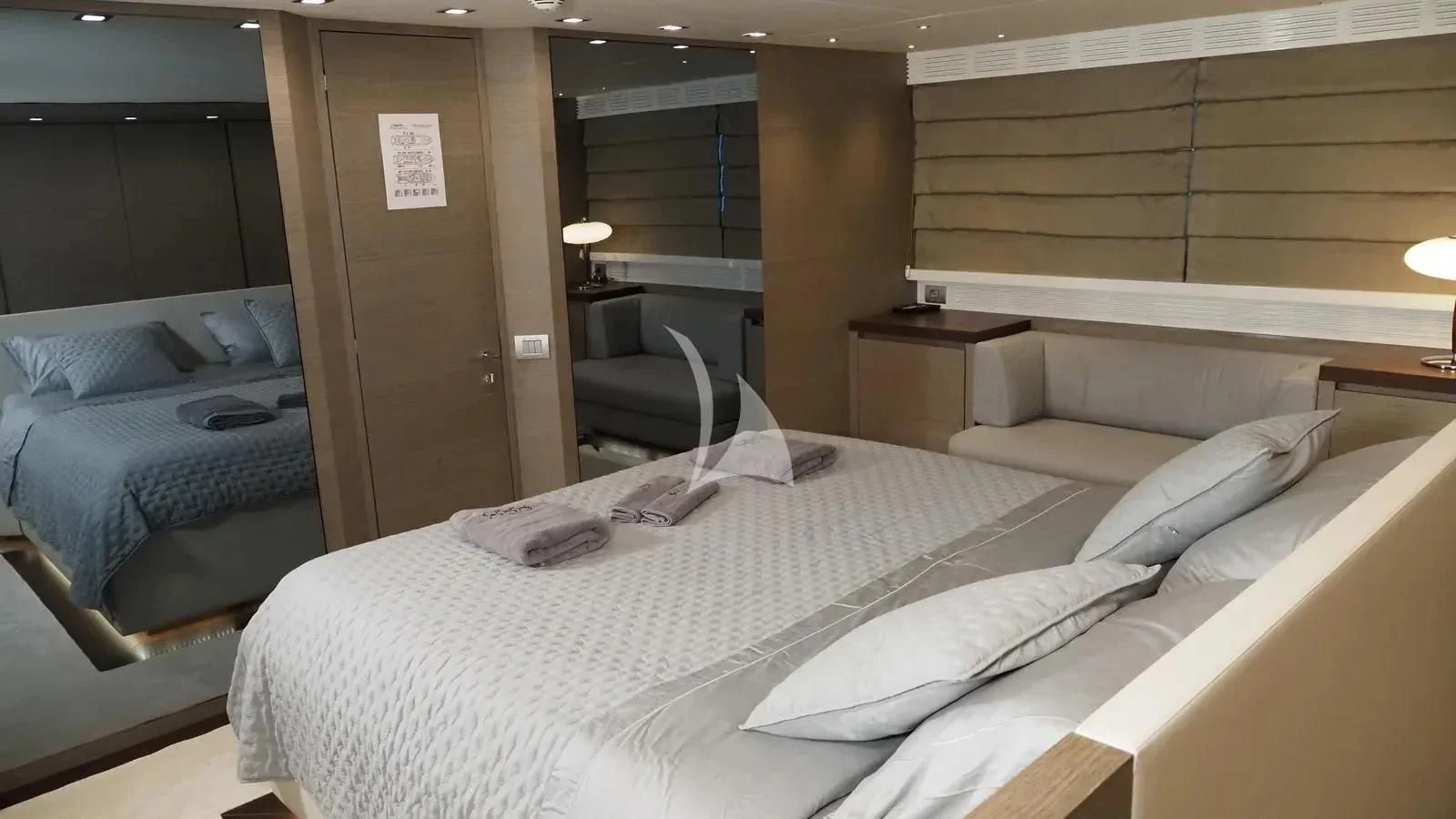 a room with beds and a chair aboard DADDY'S DREAM 888 Yacht for Charter