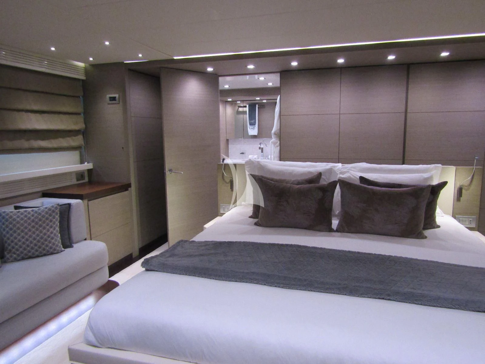 a bed with a black and white bed spread aboard DADDY'S DREAM 888 Yacht for Charter