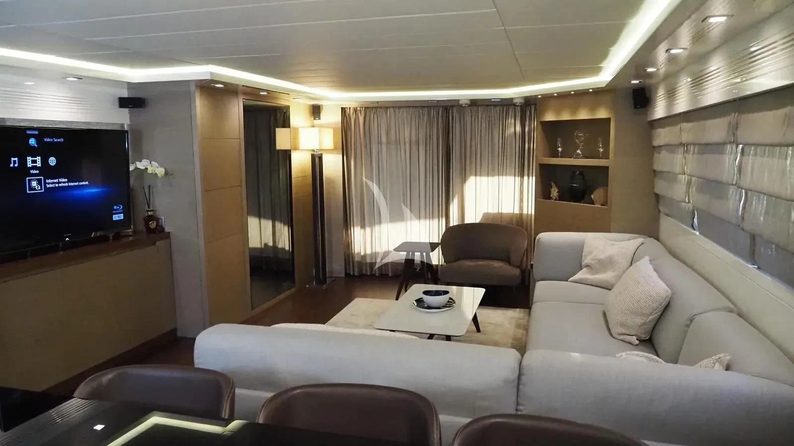 a living room with a large screen aboard DADDY'S DREAM 888 Yacht for Charter