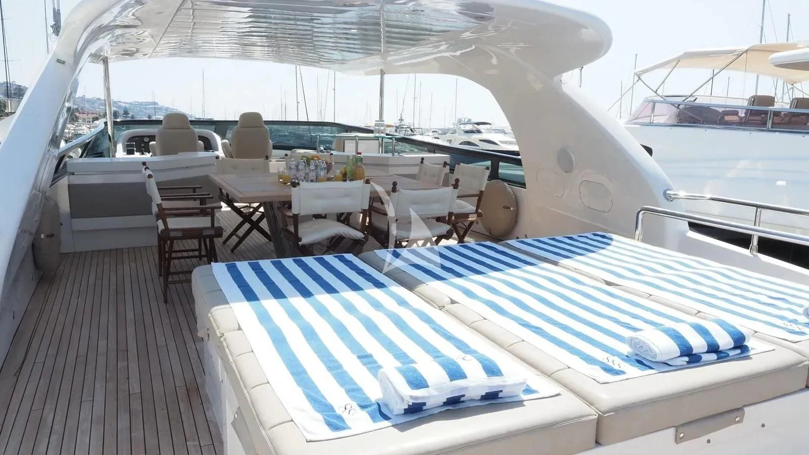a boat with a table and chairs on the deck aboard DADDY'S DREAM 888 Yacht for Charter