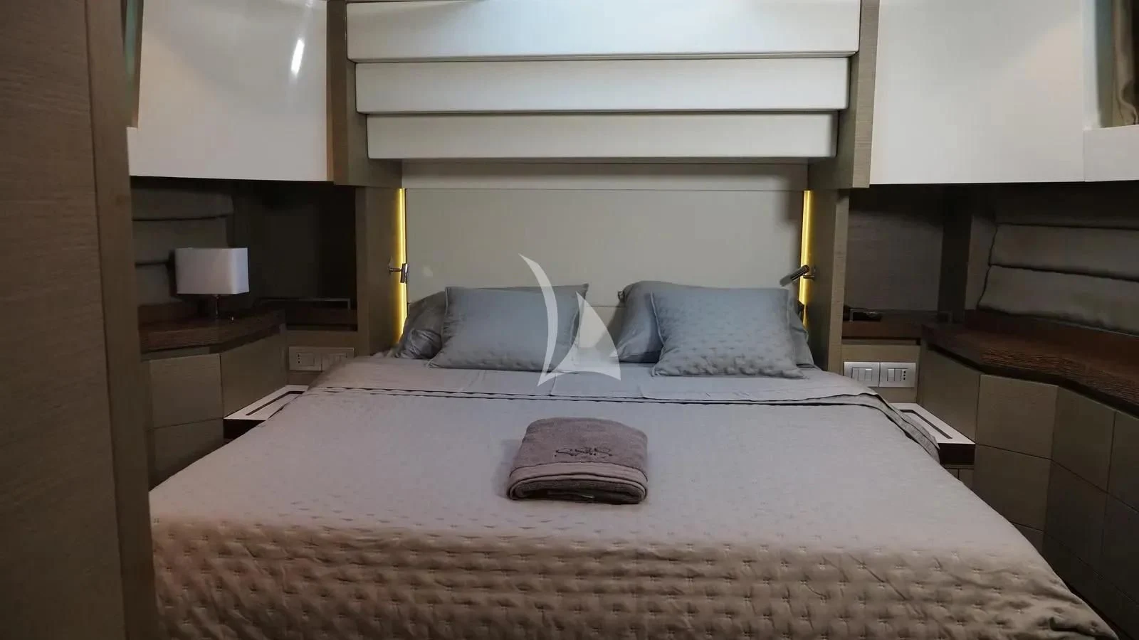 a bed with a white bed spread aboard DADDY'S DREAM 888 Yacht for Charter