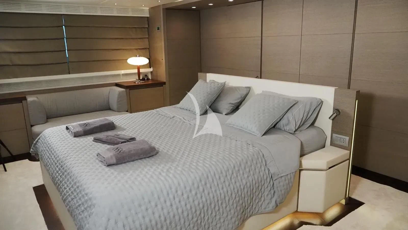 a room with a bed and a desk aboard DADDY'S DREAM 888 Yacht for Charter