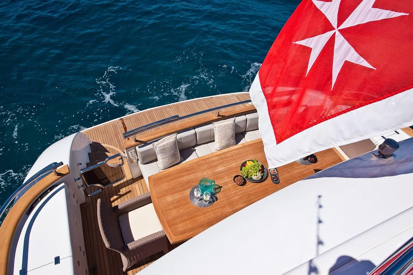 a boat with a flag on the front aboard DADDY'S DREAM 888 Yacht for Charter