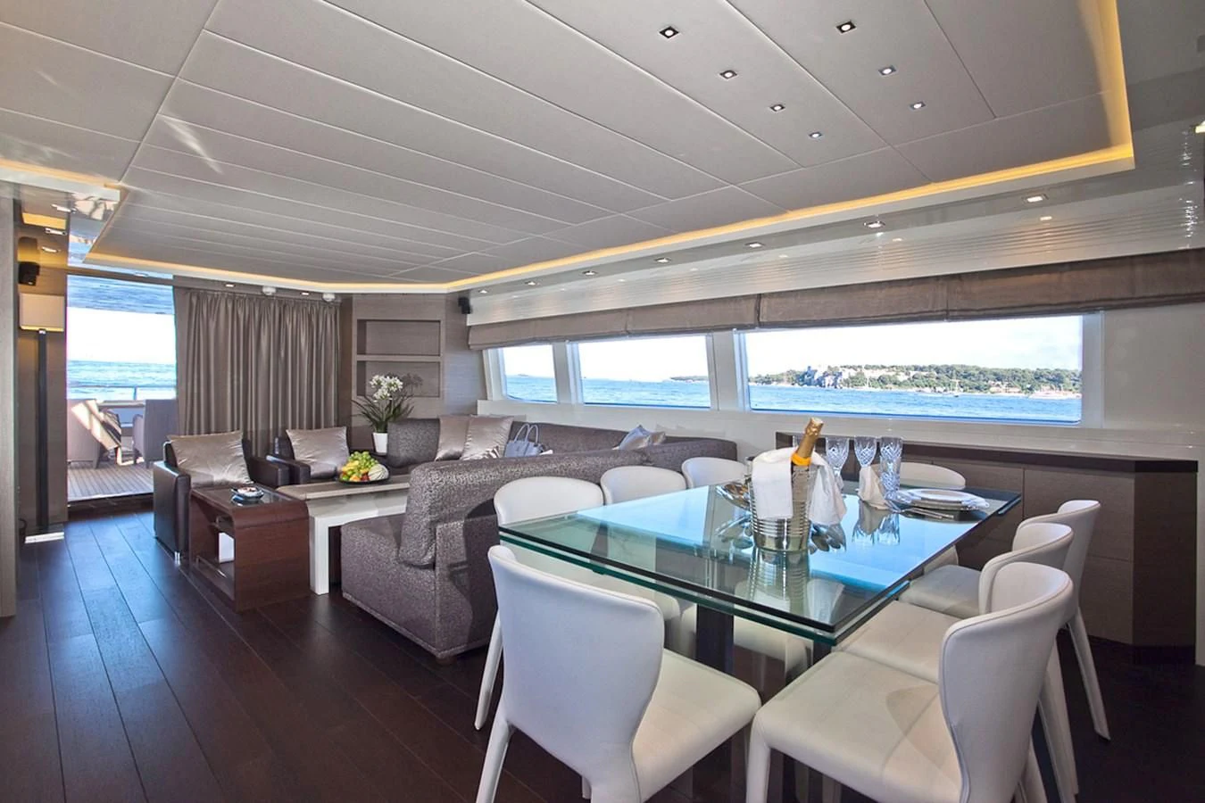 a large living room with a large table and chairs aboard DADDY'S DREAM 888 Yacht for Charter