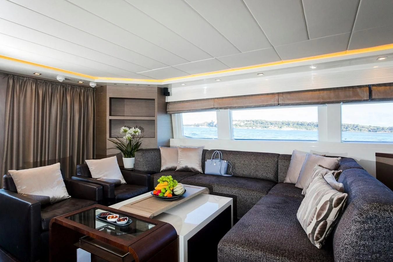 a living room with a couch and a coffee table aboard DADDY'S DREAM 888 Yacht for Charter