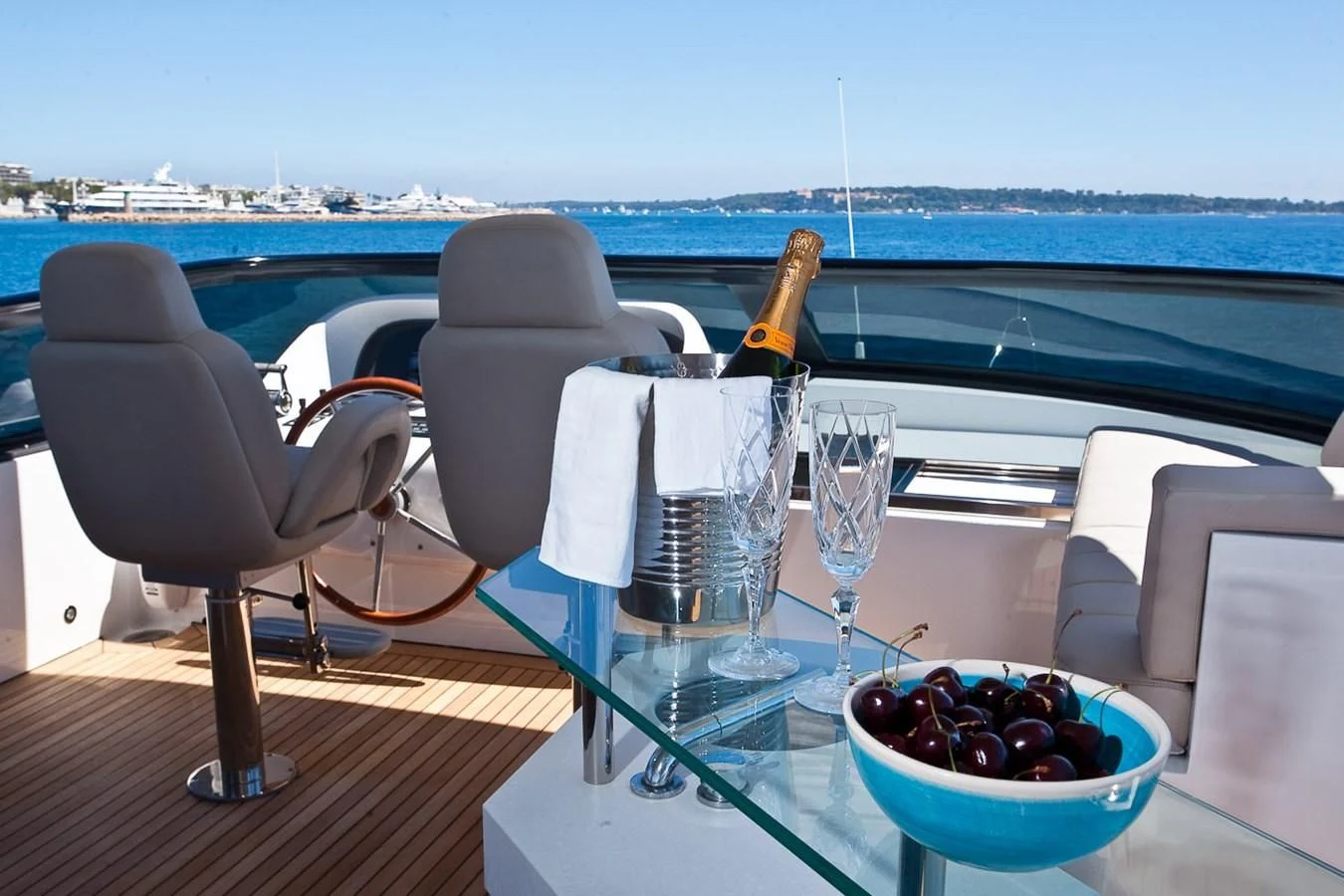 a table with chairs and a bowl of berries on it aboard DADDY'S DREAM 888 Yacht for Charter