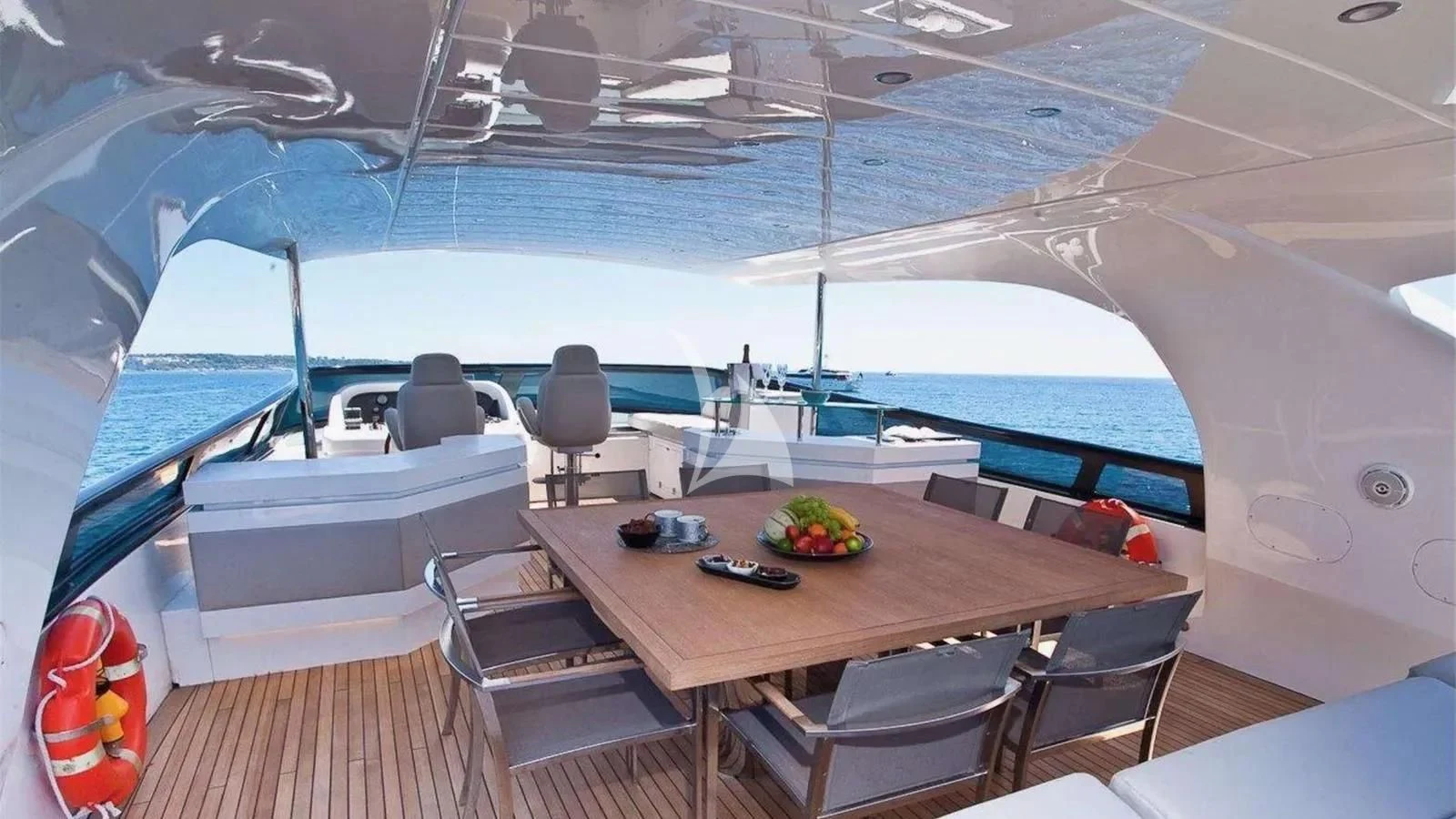 a table with chairs on it aboard DADDY'S DREAM 888 Yacht for Charter