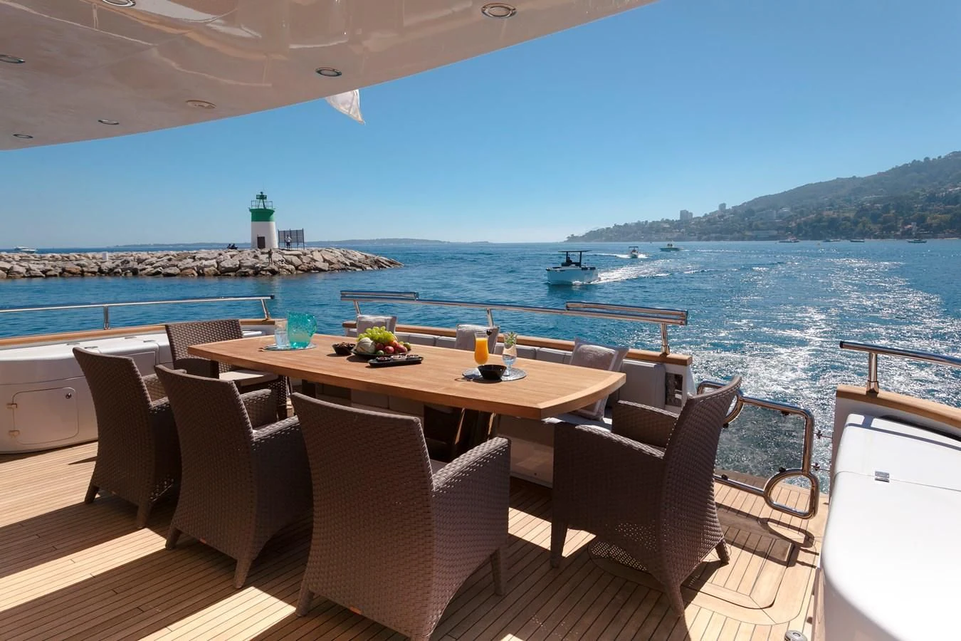 a table with chairs and a view of the water aboard DADDY'S DREAM 888 Yacht for Charter