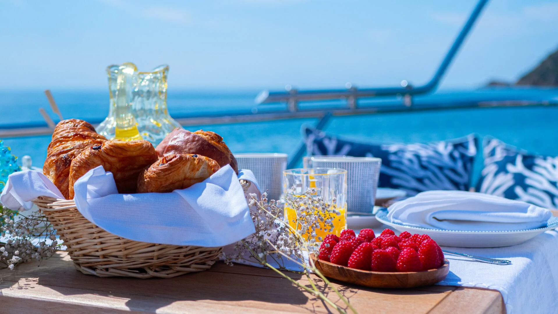 a basket of food and a bottle of water on a table aboard DADDY'S DREAM 888 Yacht for Charter