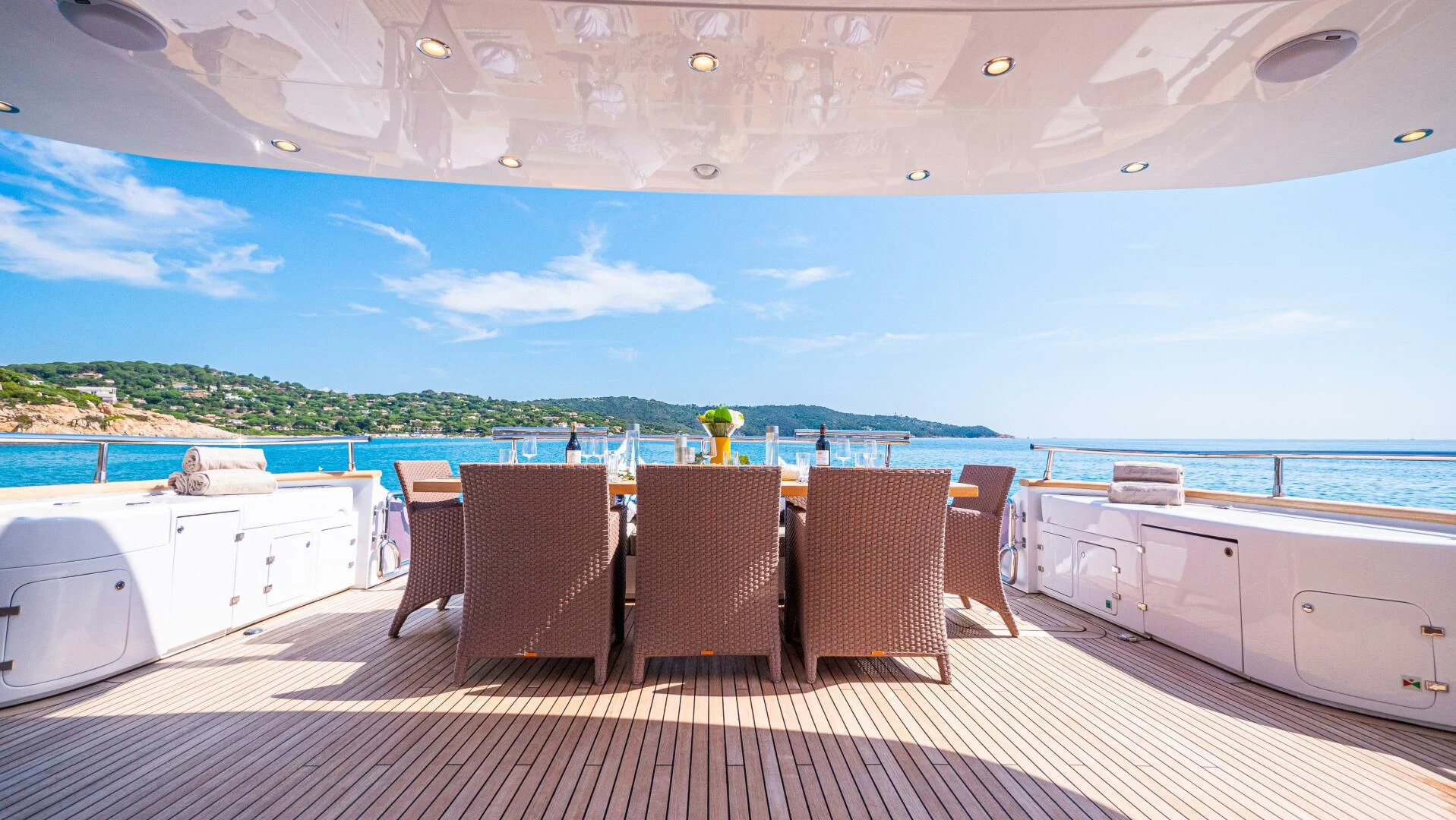 a deck with chairs and a table on it aboard DADDY'S DREAM 888 Yacht for Charter