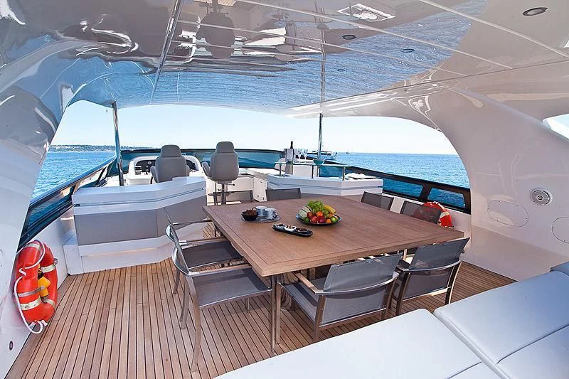 a room with a table and chairs aboard DADDY'S DREAM 888 Yacht for Charter