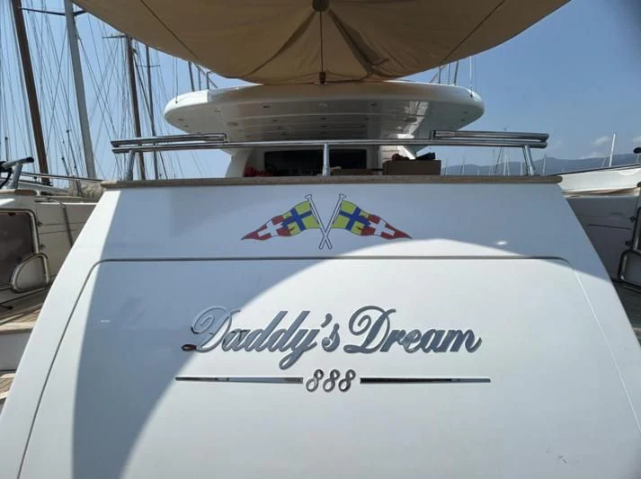 a white airplane with blue and red stripes on it aboard DADDY'S DREAM 888 Yacht for Charter
