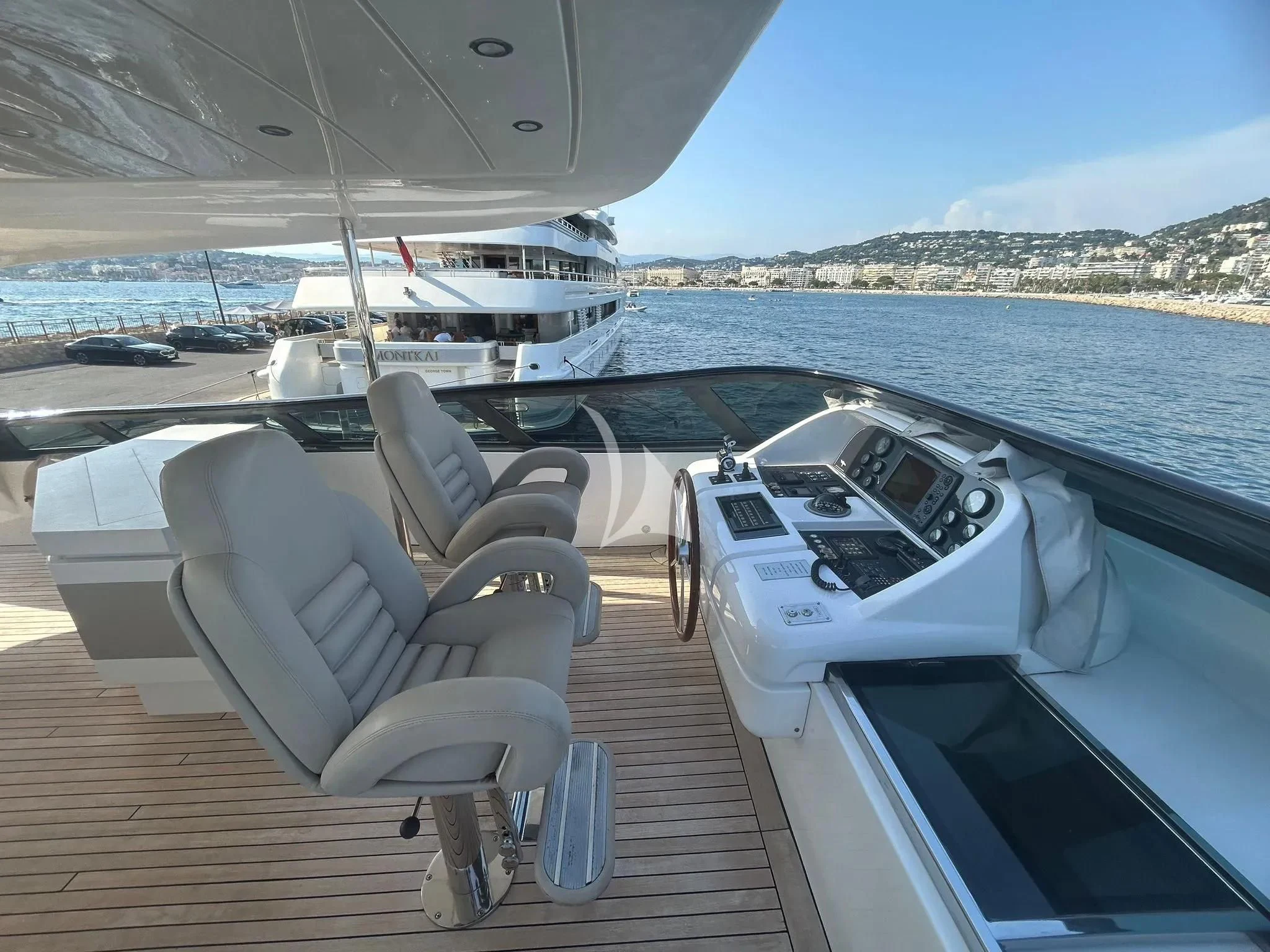 a deck with chairs on it and boats in the water aboard DADDY'S DREAM 888 Yacht for Charter