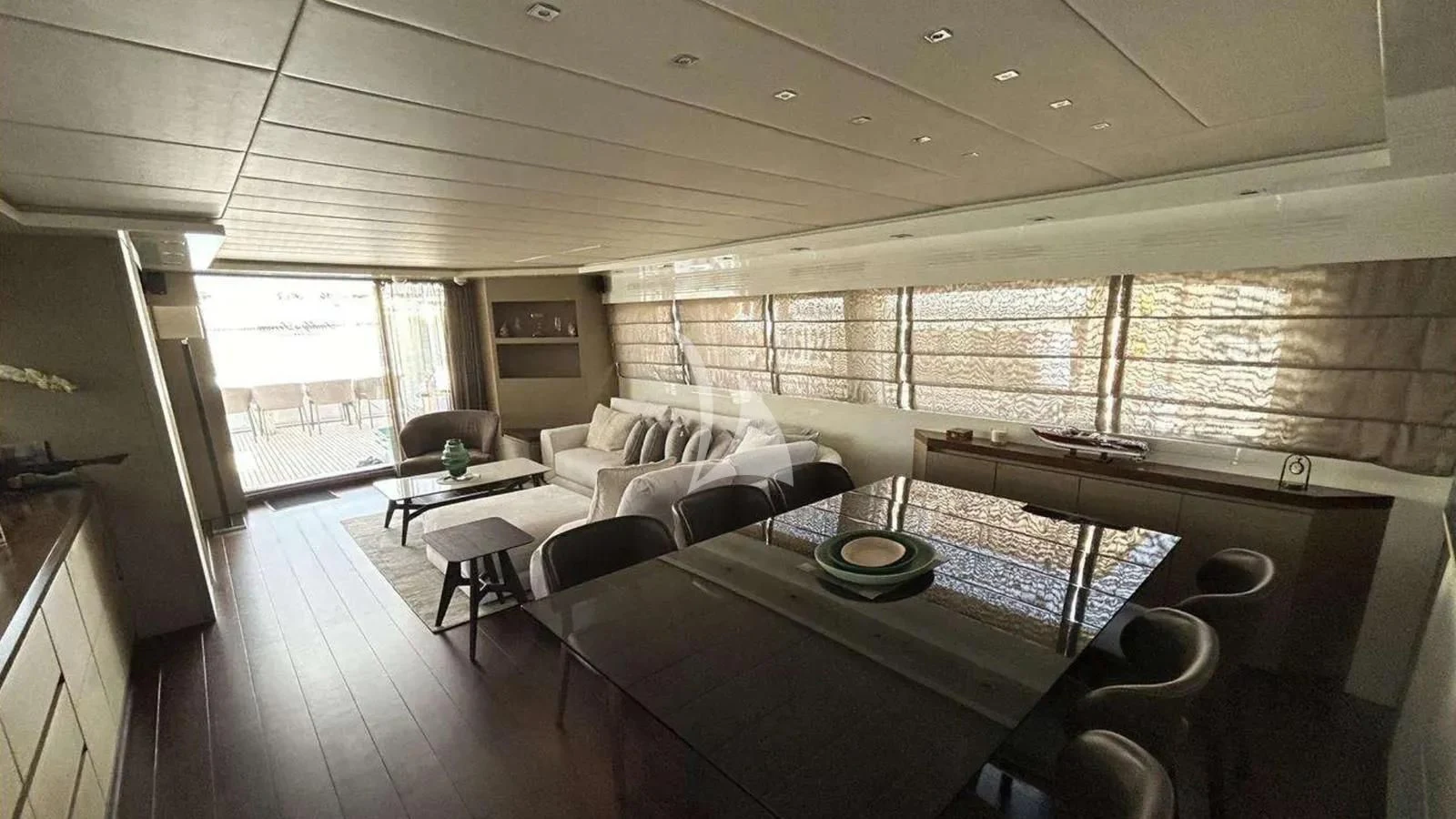 a large living room with a large table and chairs aboard DADDY'S DREAM 888 Yacht for Charter