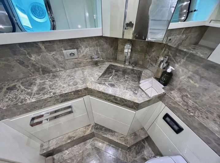 a bathroom with a marble counter top aboard DADDY'S DREAM 888 Yacht for Charter