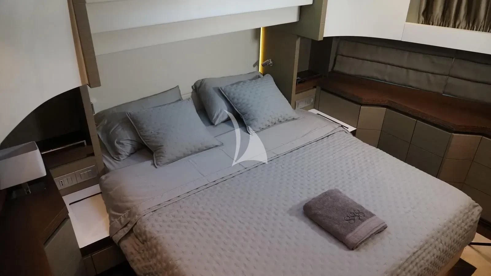 a bed with a white sheet and pillows aboard DADDY'S DREAM 888 Yacht for Charter