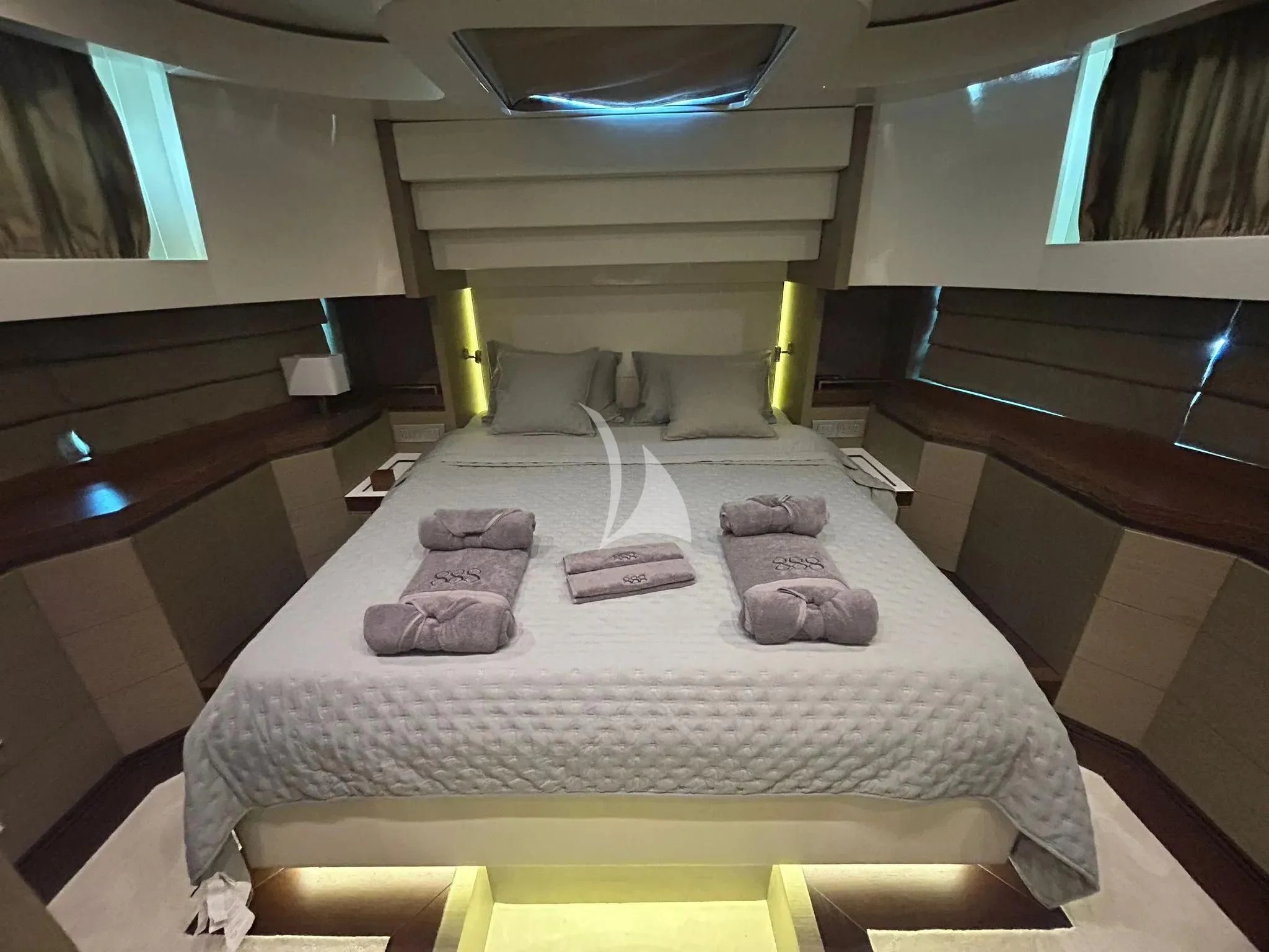 a bed with a couple of pillows on it aboard DADDY'S DREAM 888 Yacht for Charter
