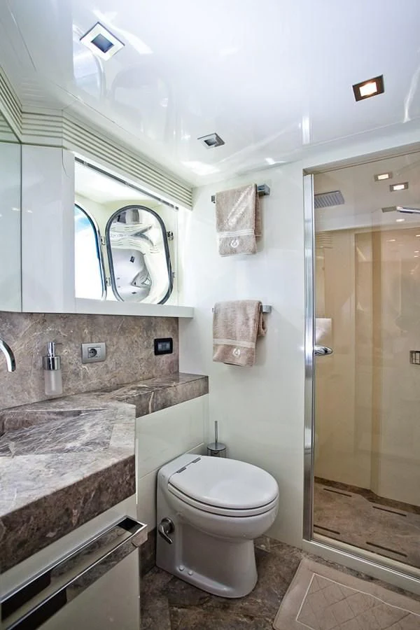 a bathroom with marble counter tops aboard DADDY'S DREAM 888 Yacht for Charter
