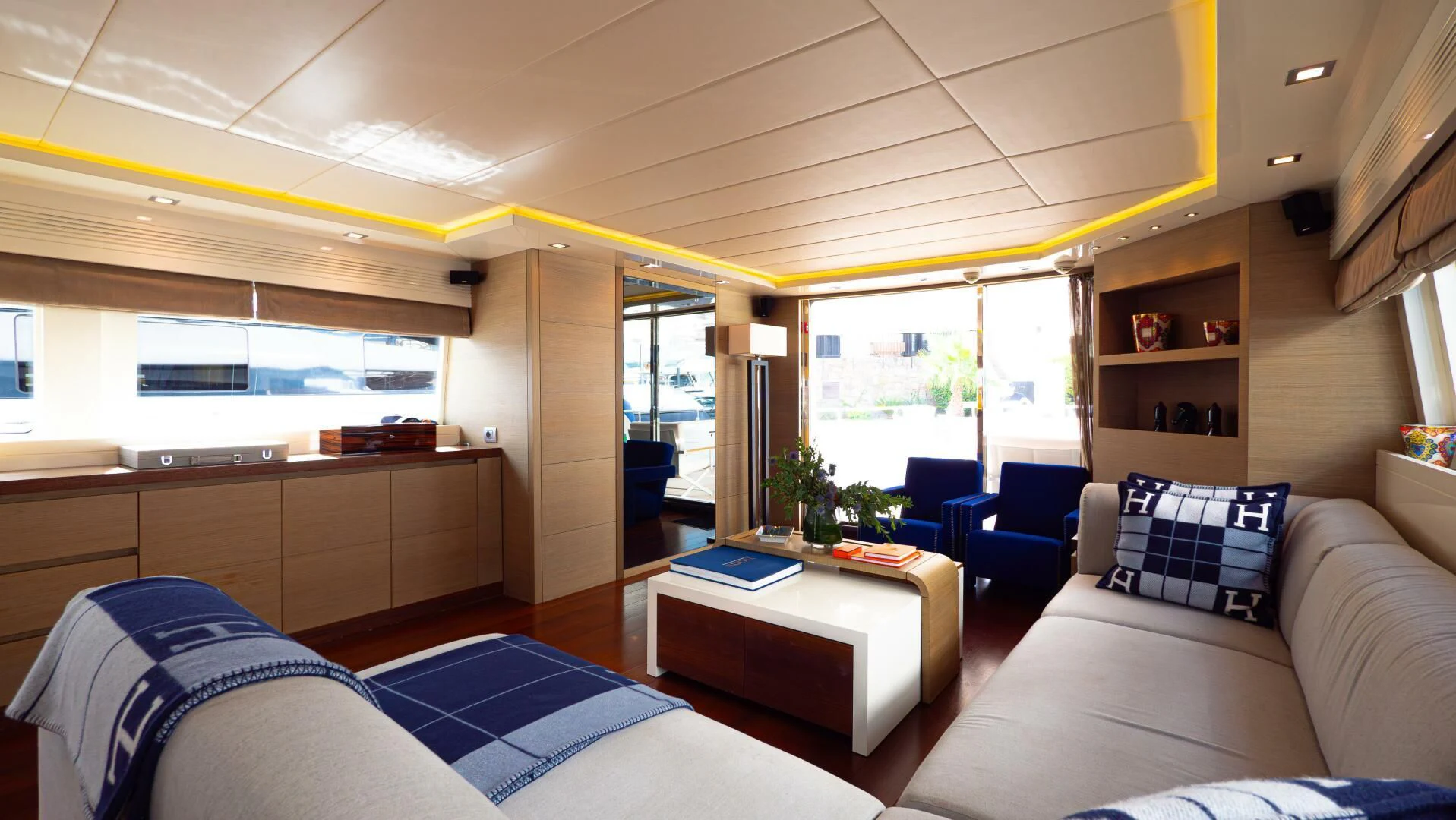 a room with a couch and a table and chairs aboard DADDY'S DREAM 888 Yacht for Charter