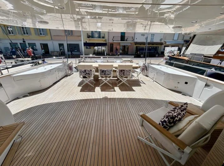 a room with tables and chairs aboard DADDY'S DREAM 888 Yacht for Charter