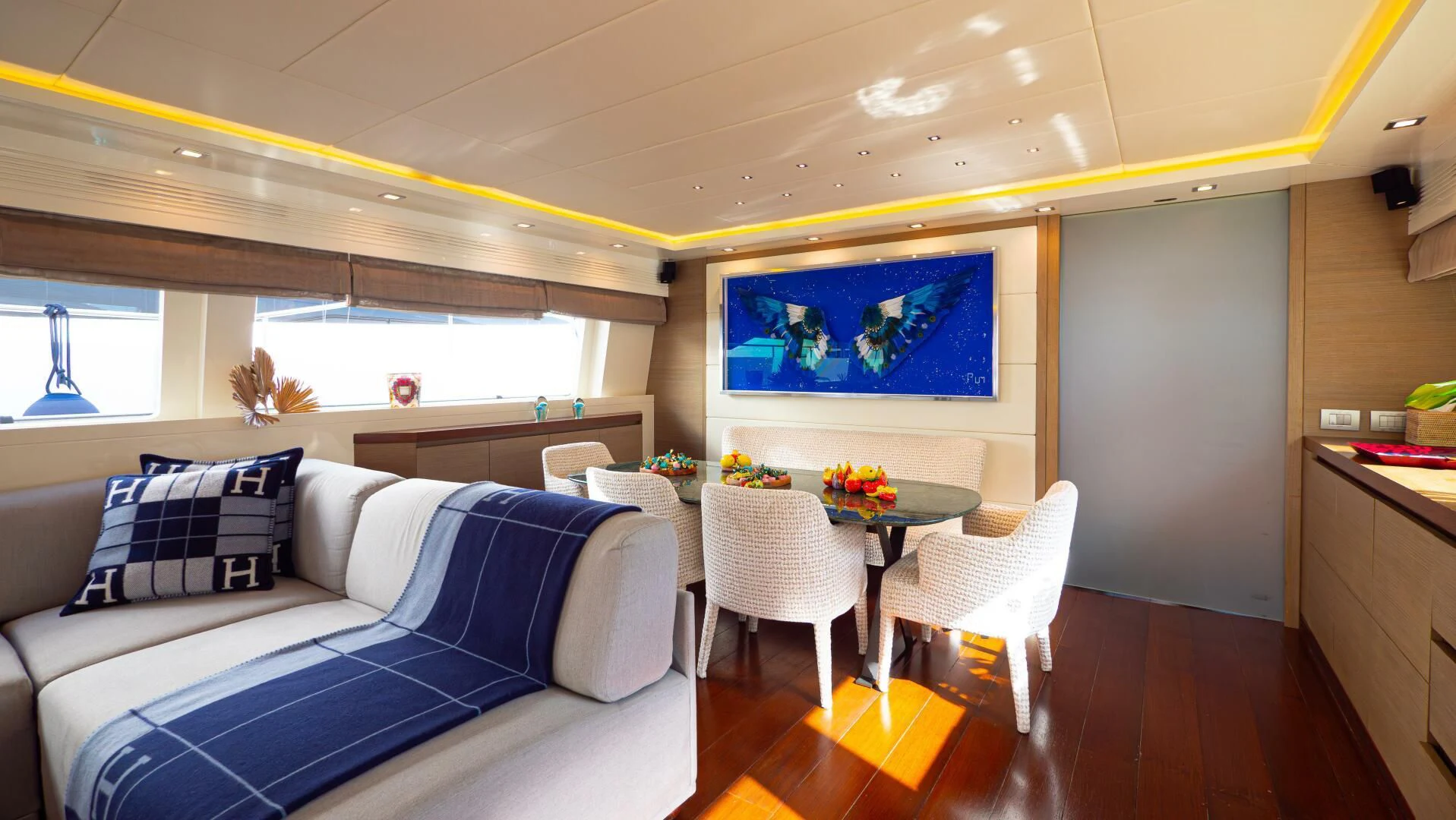a living room with a blue and white couch and a table aboard DADDY'S DREAM 888 Yacht for Charter