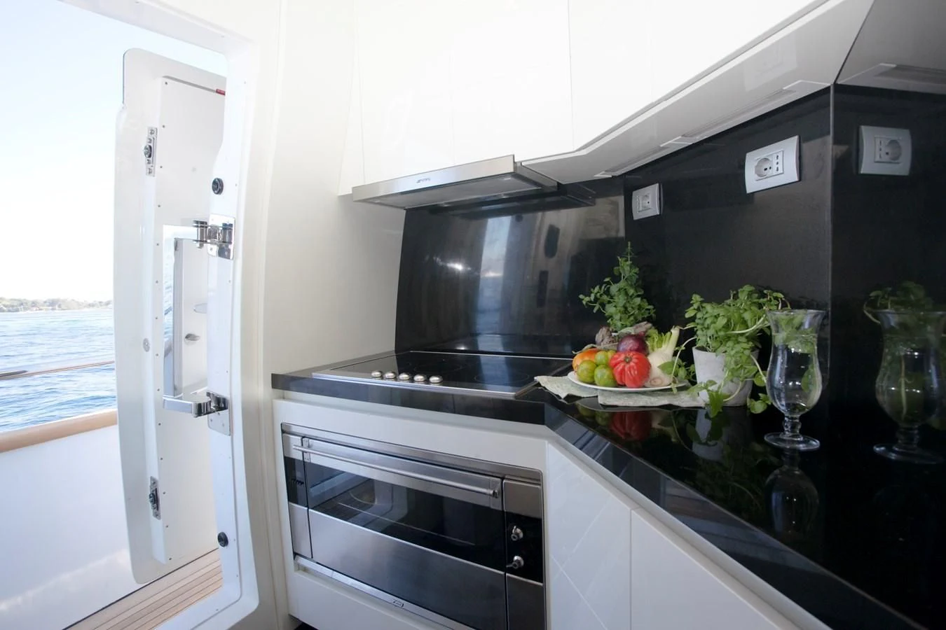 a kitchen with a sink and a microwave aboard DADDY'S DREAM 888 Yacht for Charter