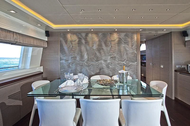 a dining table with plates and chairs aboard DADDY'S DREAM 888 Yacht for Charter