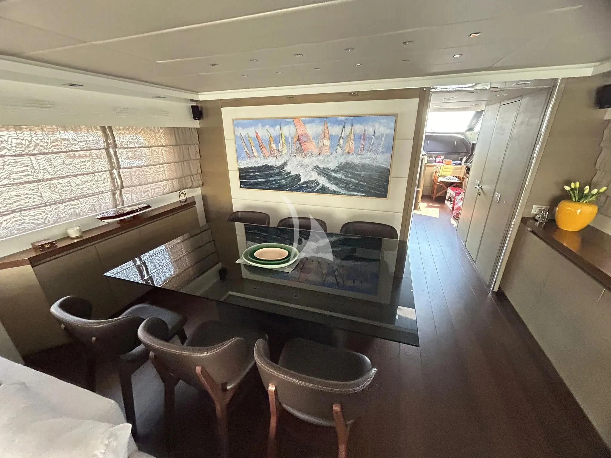 a room with a table and chairs aboard DADDY'S DREAM 888 Yacht for Charter