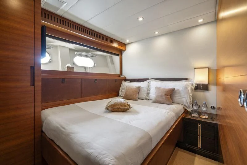 a bed with a white bed spread aboard ECLAT Yacht for Sale