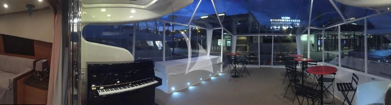 a room with tables and chairs aboard ECLAT Yacht for Sale