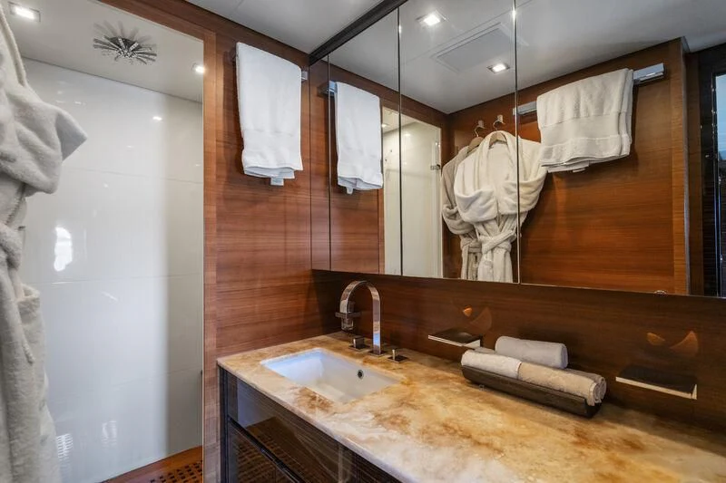 a bathroom with a large mirror aboard ECLAT Yacht for Sale