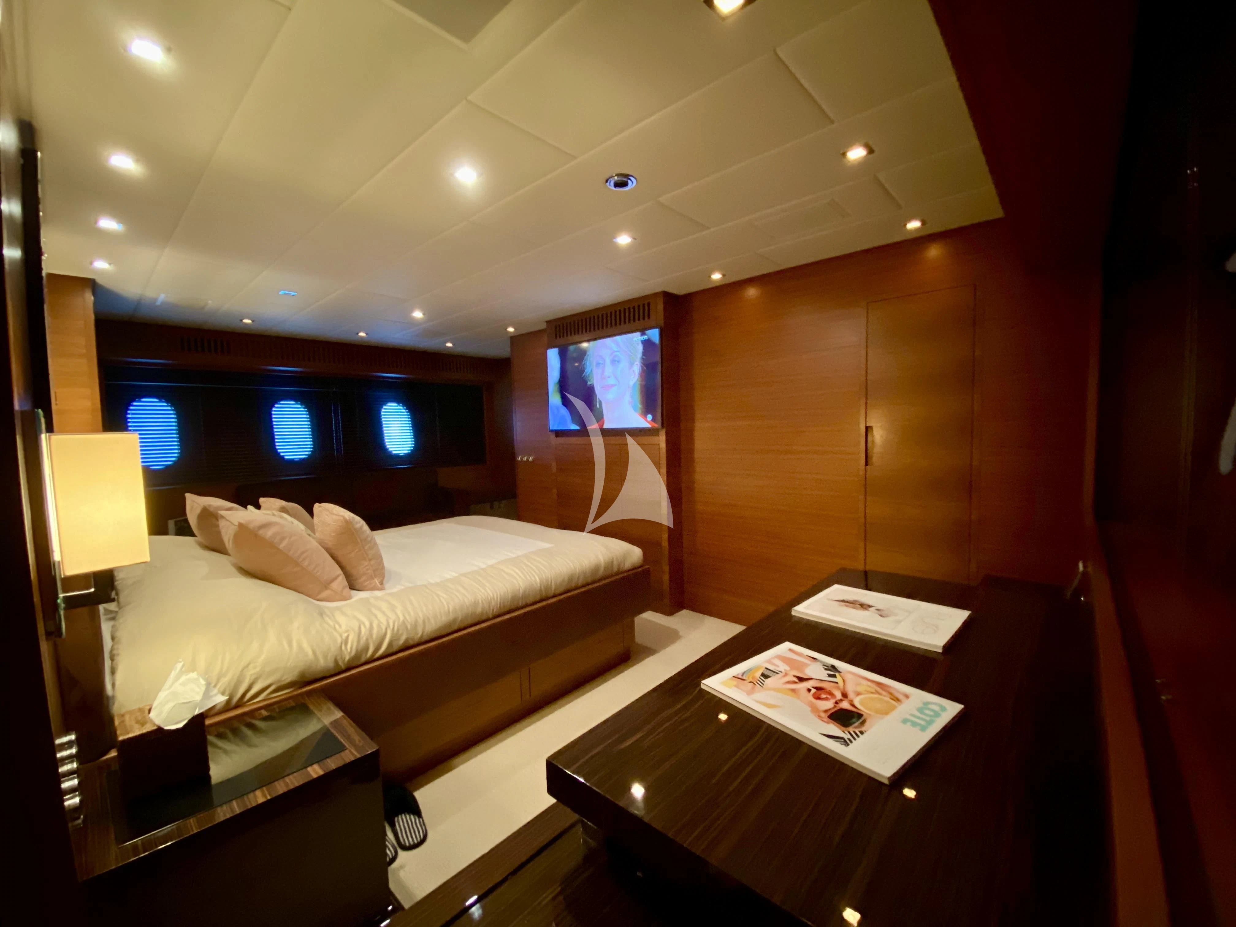 a hotel room with a bed and a desk aboard ECLAT Yacht for Sale