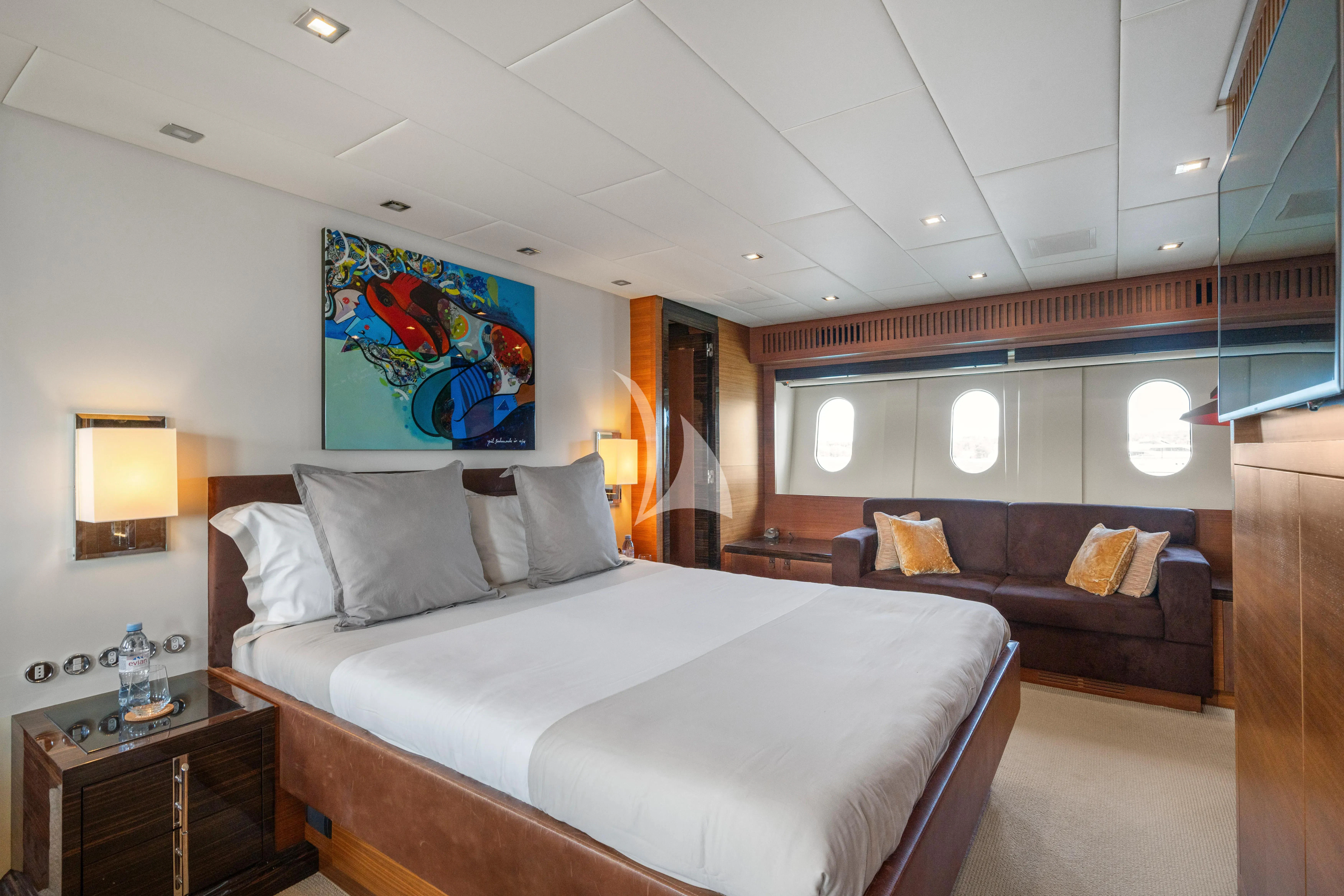 a hotel room with a bed and a couch aboard ECLAT Yacht for Sale