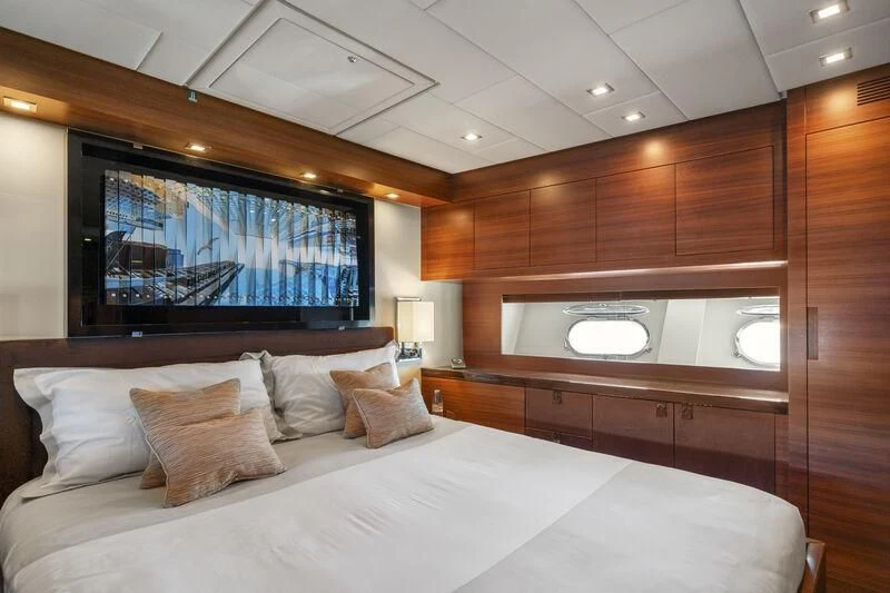 a bed with a television on the wall aboard ECLAT Yacht for Sale