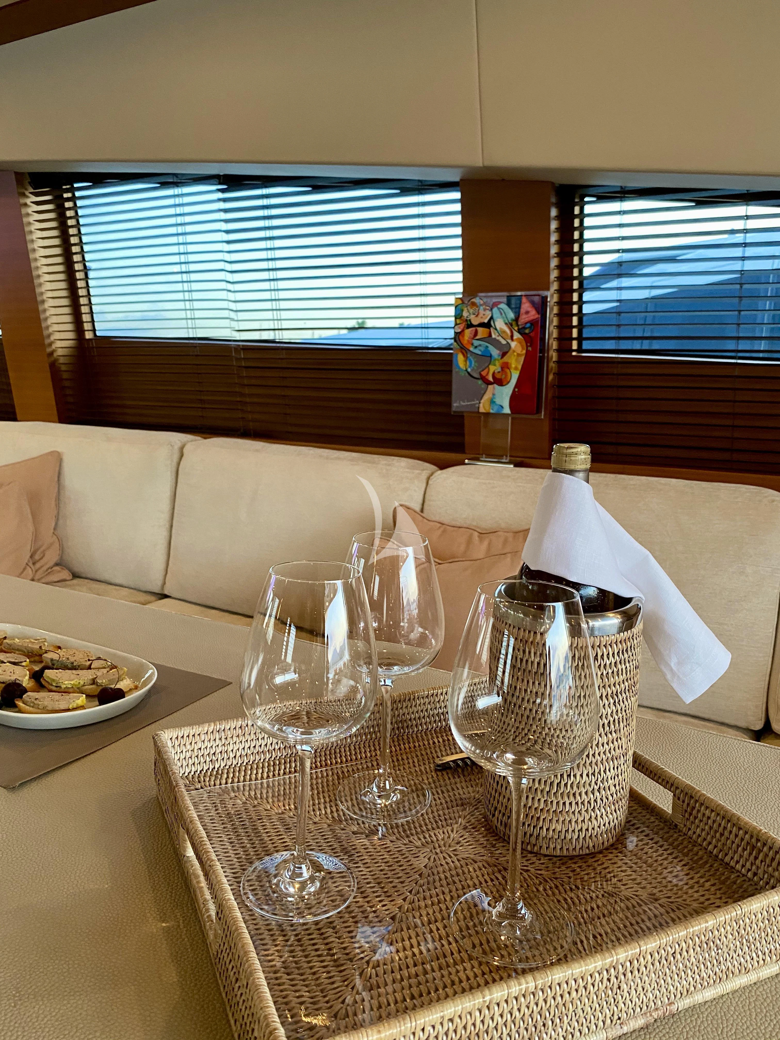 a table with glasses and food on it aboard ECLAT Yacht for Sale