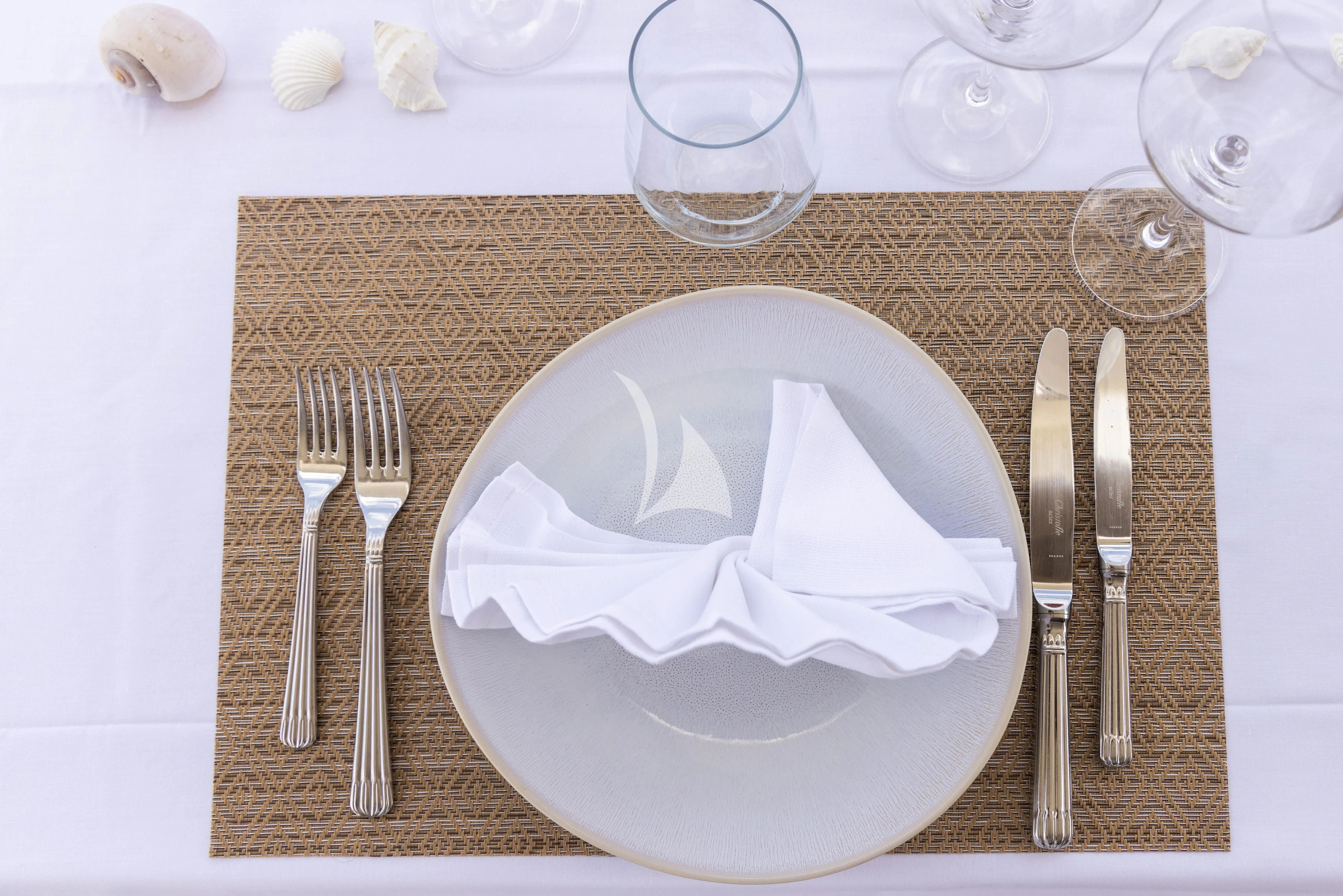 a plate with napkins and silverware on it aboard ECLAT Yacht for Sale