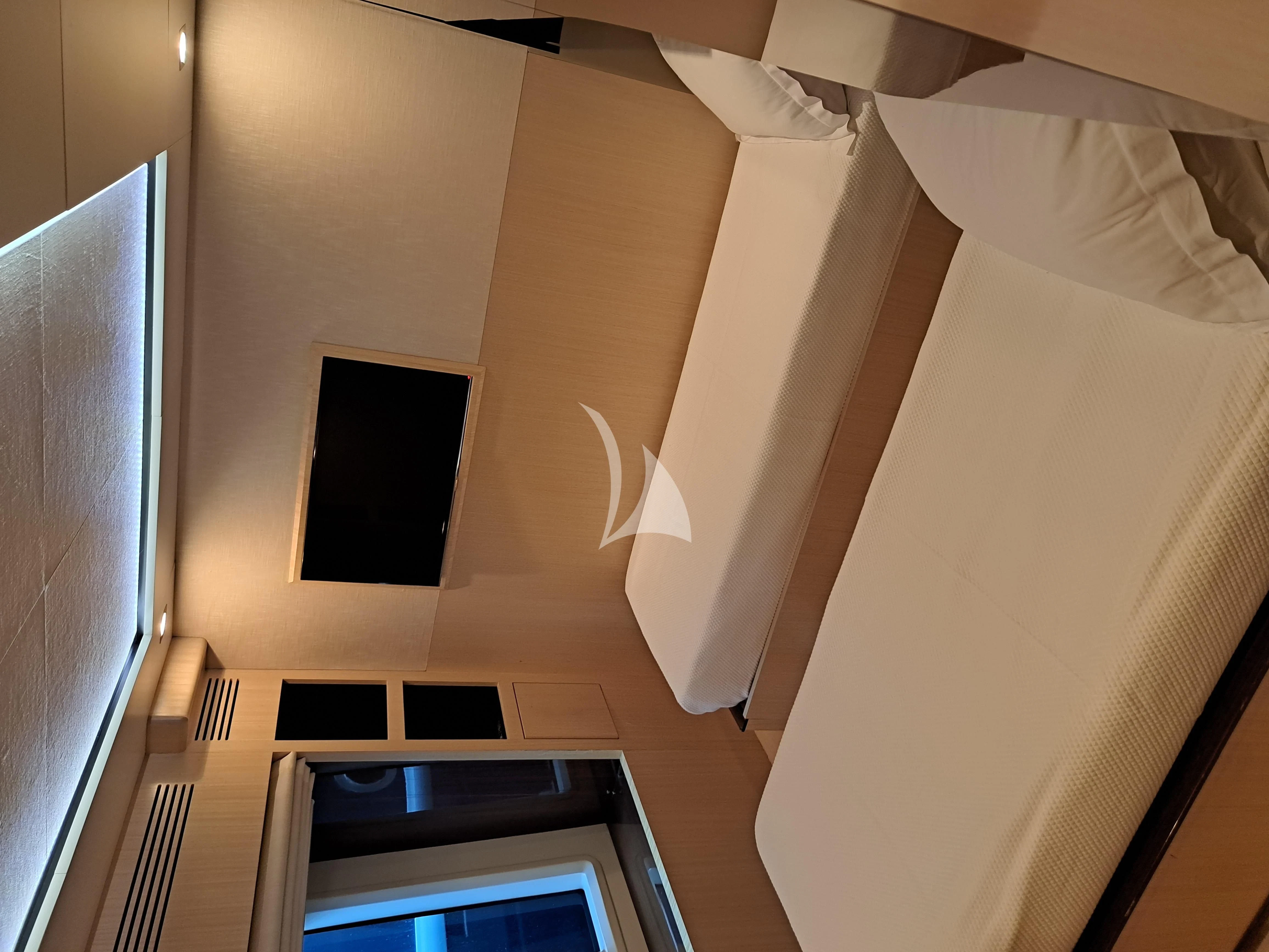 a room with a bed and a television aboard HUBO Yacht for Sale