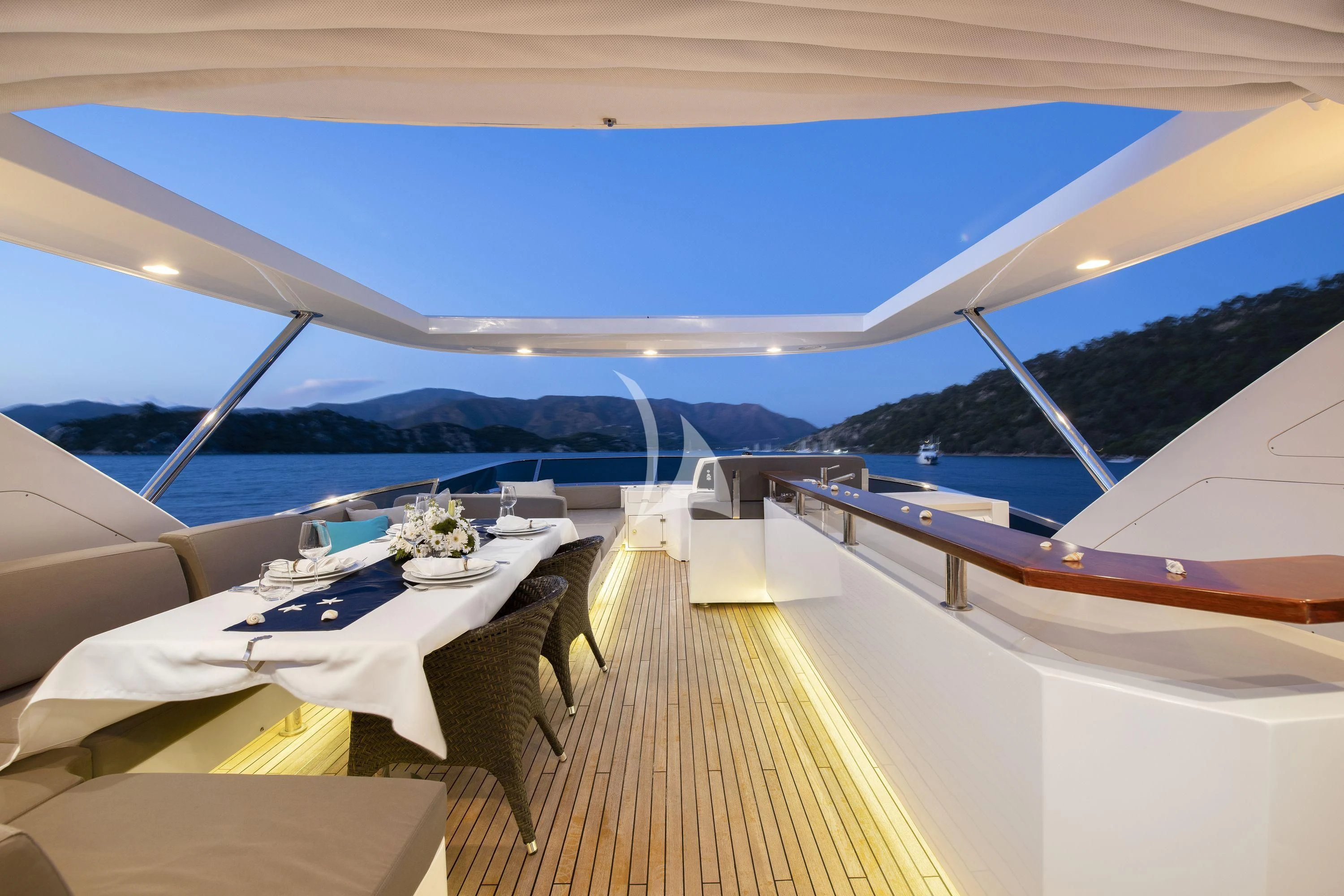 a room with a view of the ocean and mountains aboard HUBO Yacht for Sale