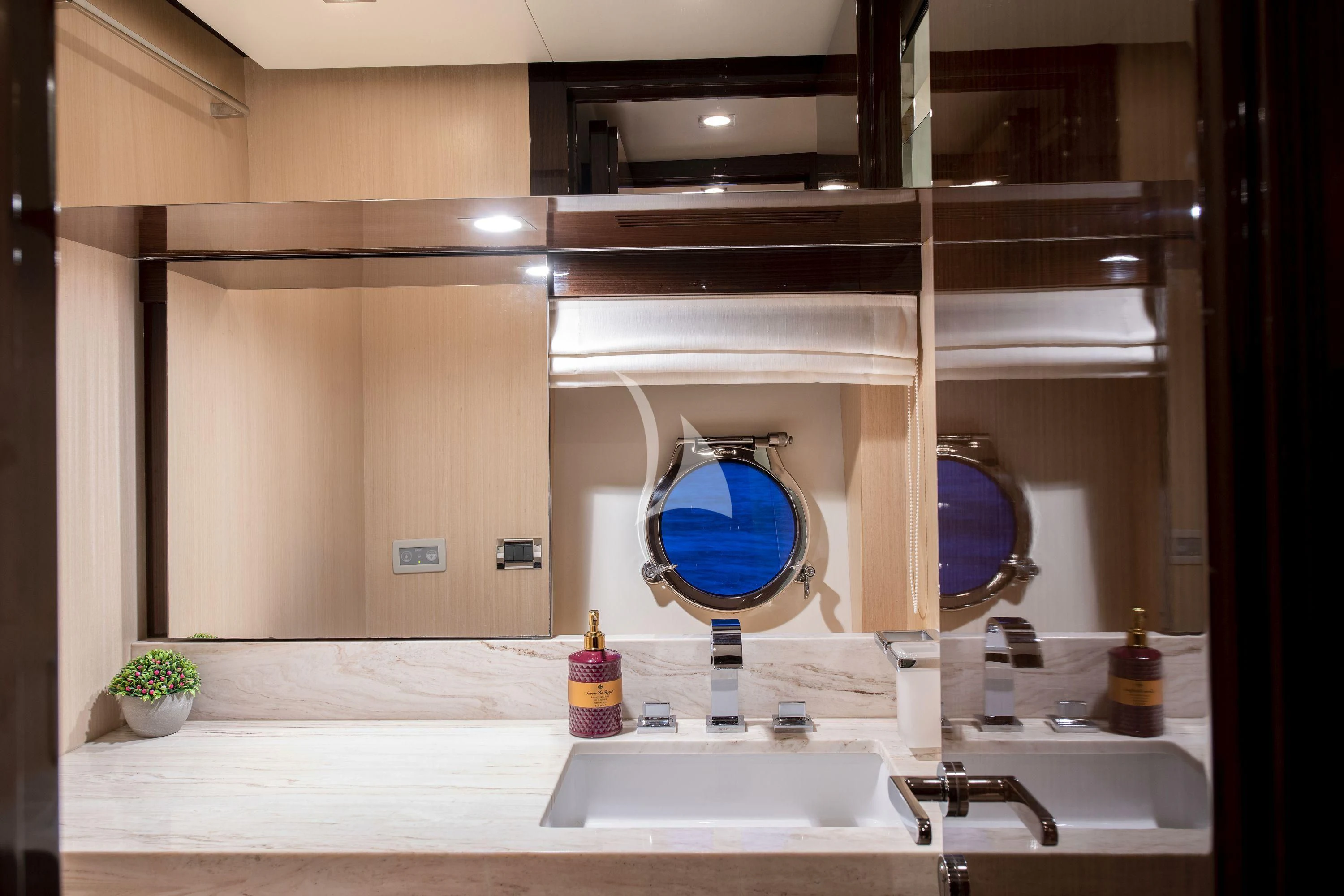a bathroom with a large mirror aboard HUBO Yacht for Sale