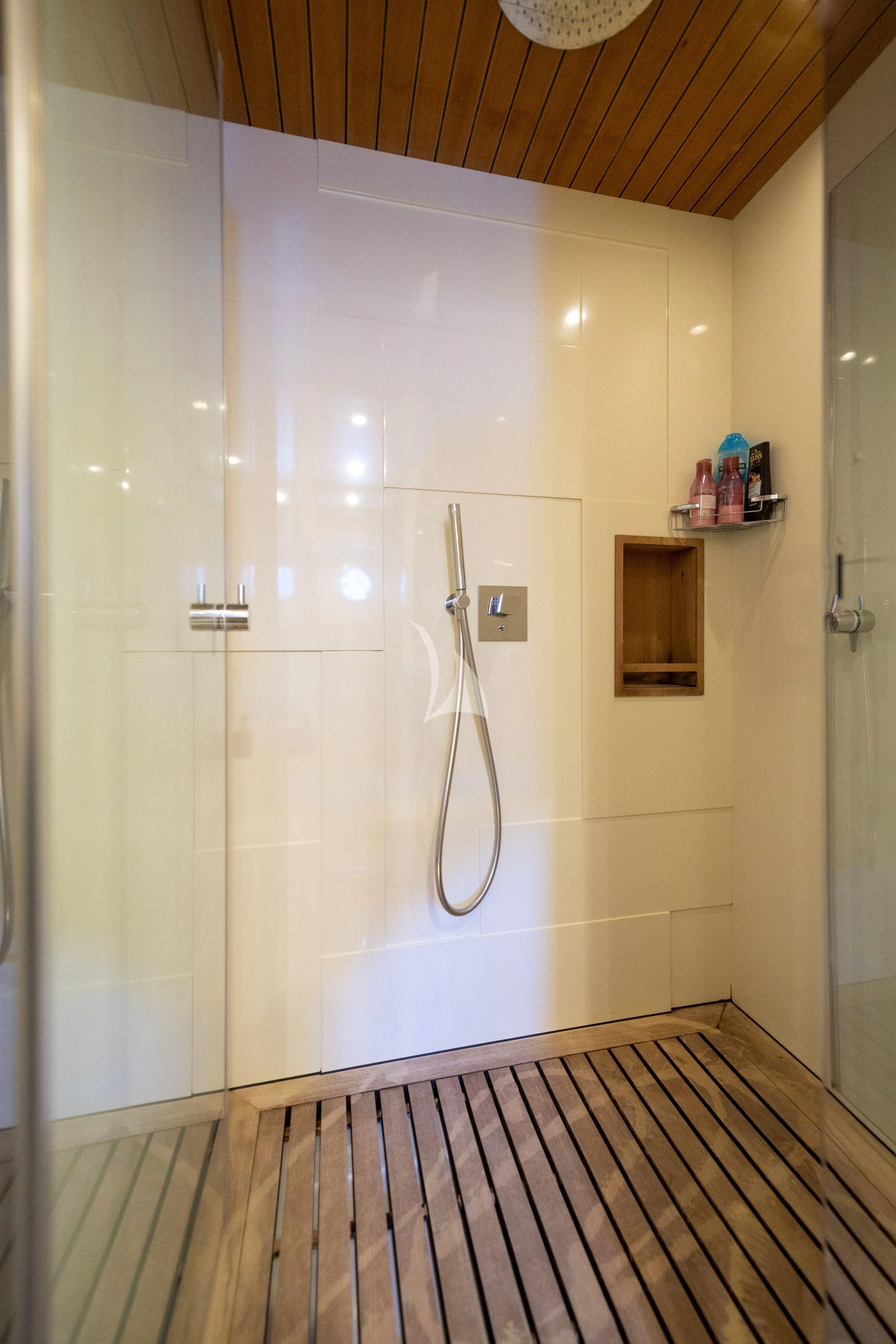 a shower with a wood floor aboard HUBO Yacht for Sale