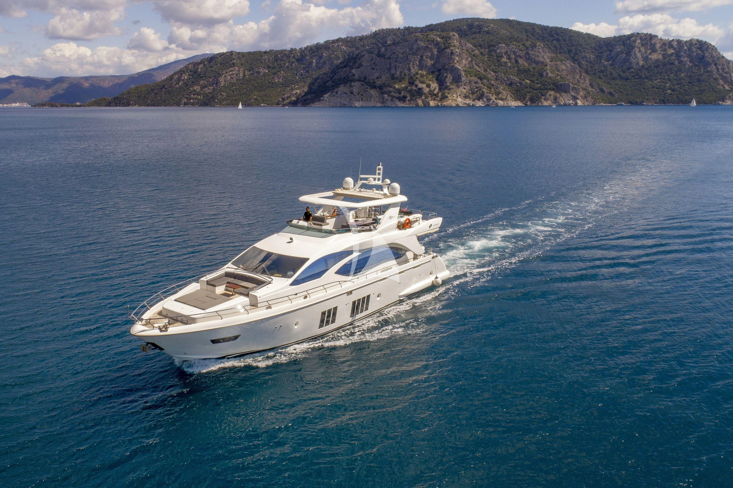 a white boat on the water aboard HUBO Yacht for Sale