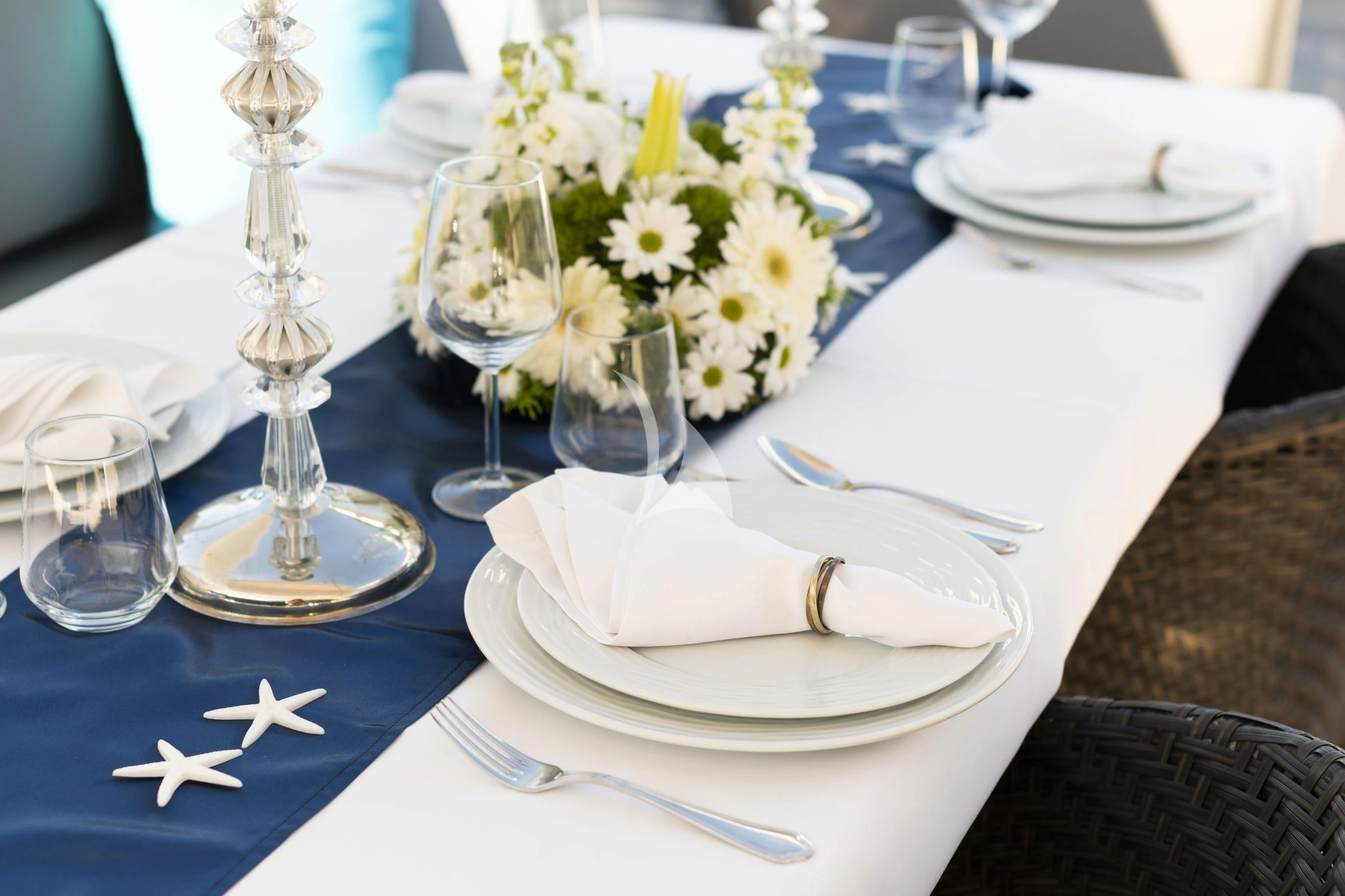 a table with plates and glasses aboard HUBO Yacht for Sale